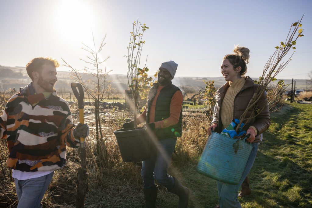 A group of volunteers wearing warm casual clothing and accessories on a sunny cold winters day