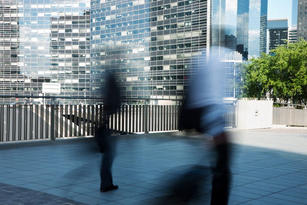 People walking outside of skyscraper