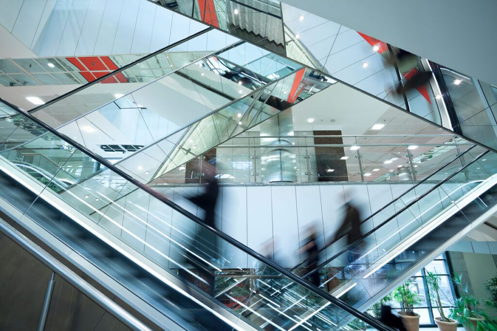 People riding escalator