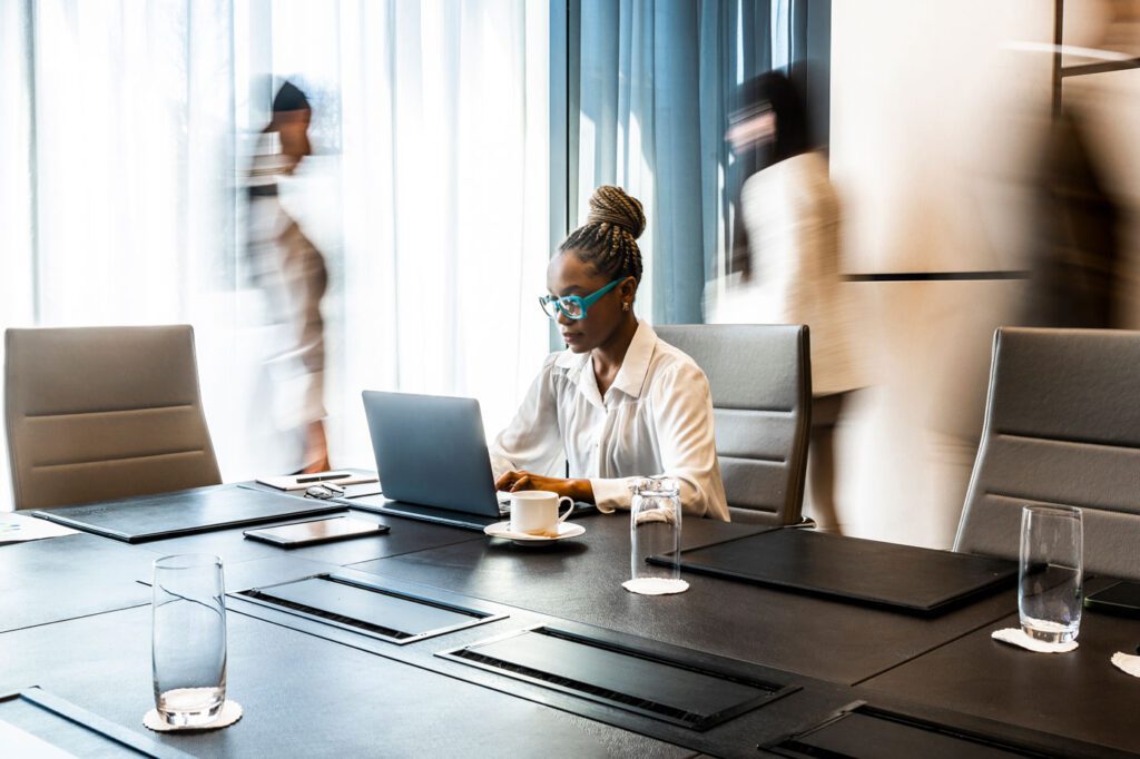 Women working on laptop in meeting room