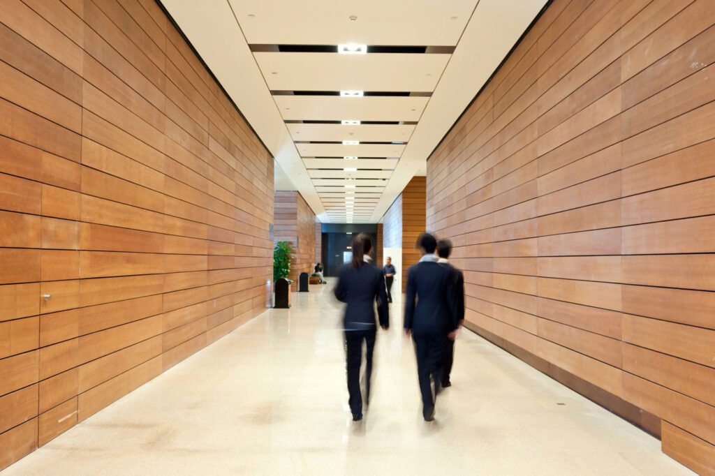Blurred view of people walking in office corridor