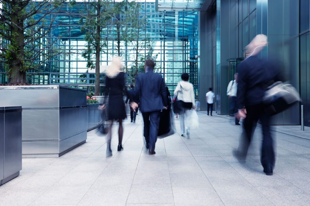 People walking into modern office building