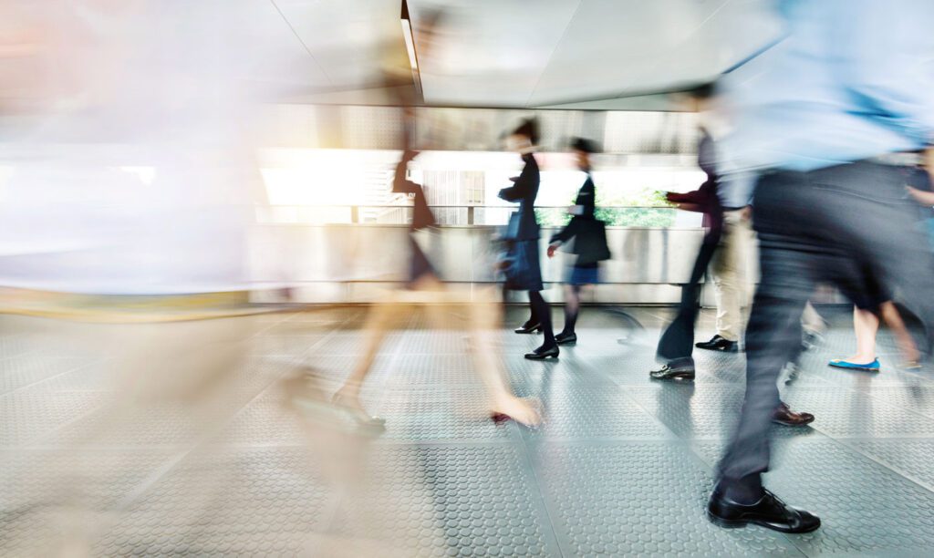 Blurry image of people walking in hall