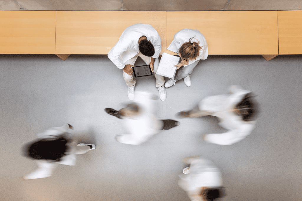 Two people sat in a busy hall