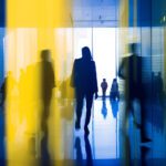 Abstract image of people walking through office