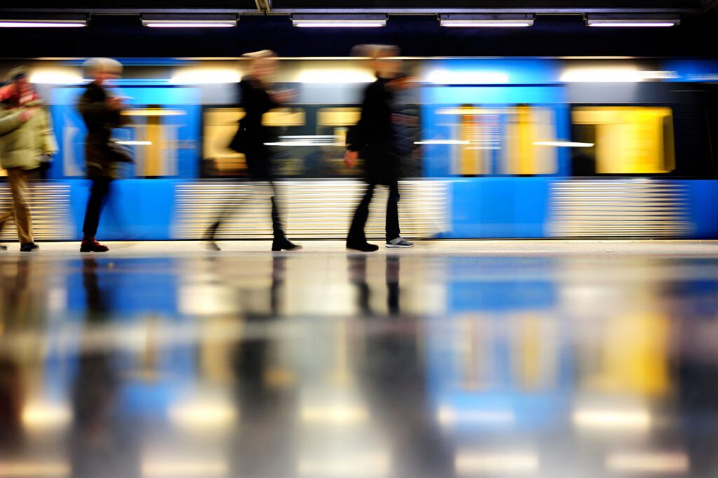 Subway train in profile, and commuters