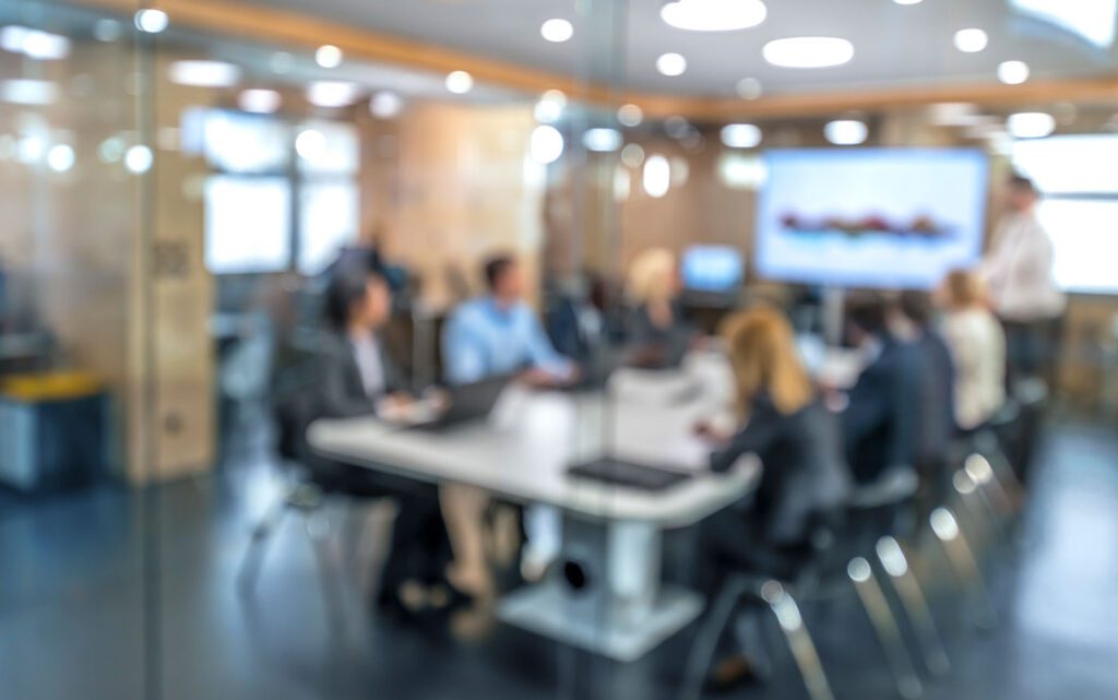 Blurry image of people sat in office