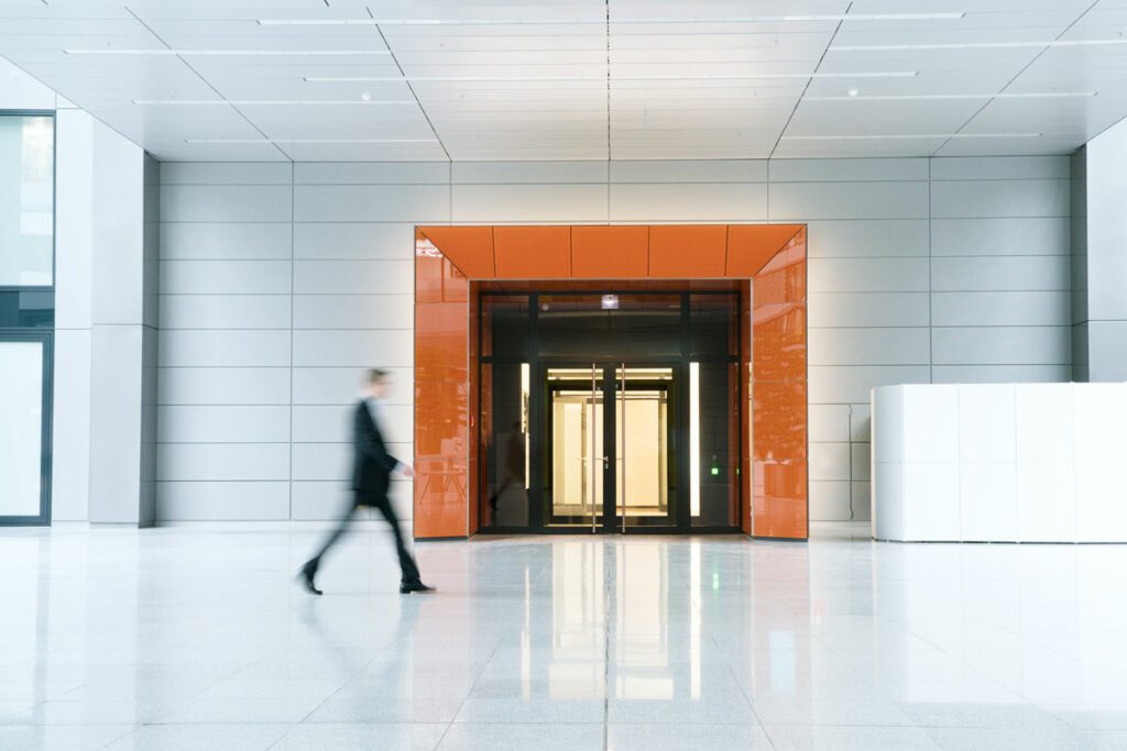 Blurred business man walking in modern architecture