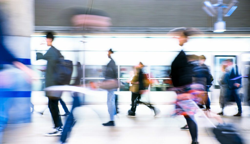 Motion blur of walking people. People on the way to work, rushing through the underground tunnel. London, UK