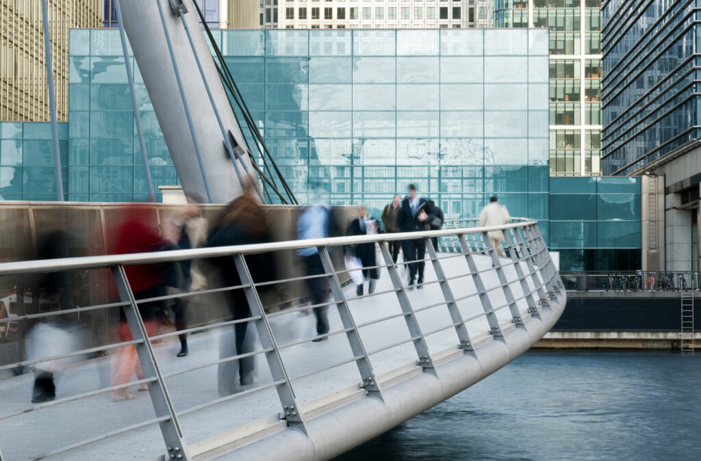 Long exposure of commuters on walkway bridge