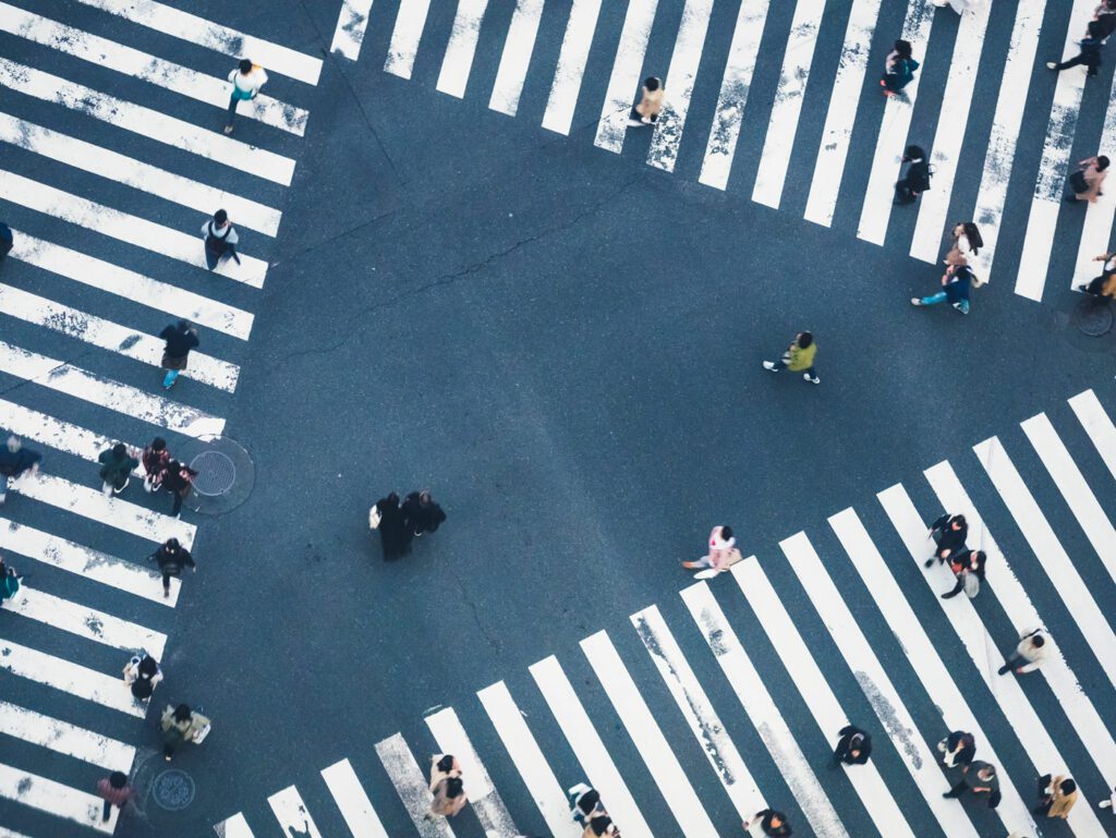 People walking on Crossing city street crosswalk top view