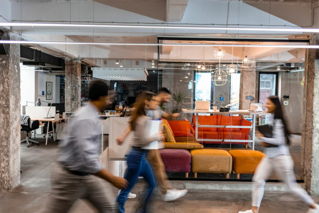 Several business people walking in the corridor.