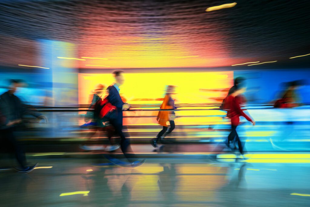 Motion-blurred people walking to the airport terminal