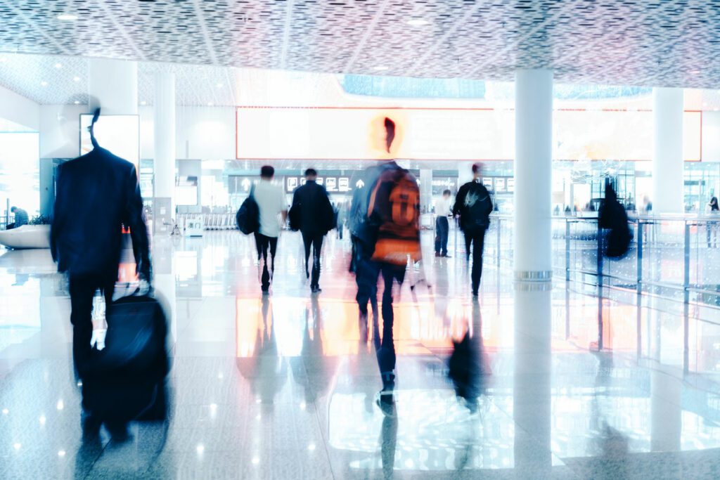 Motion Blur of People Walking in modern corridor with glass and steel