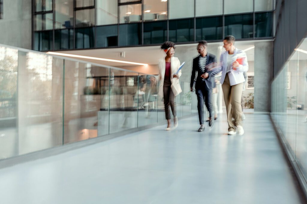 Motion blur of business people walking through the office corridor
