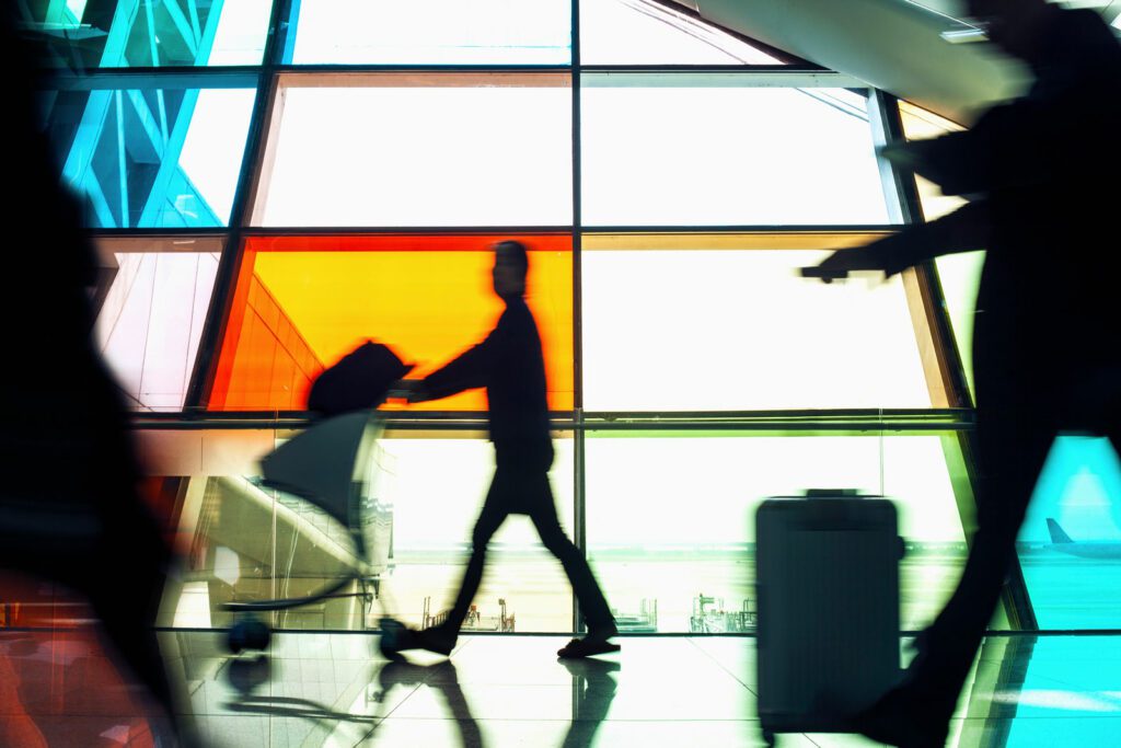 Passengers pushing luggage carts in airport terminal