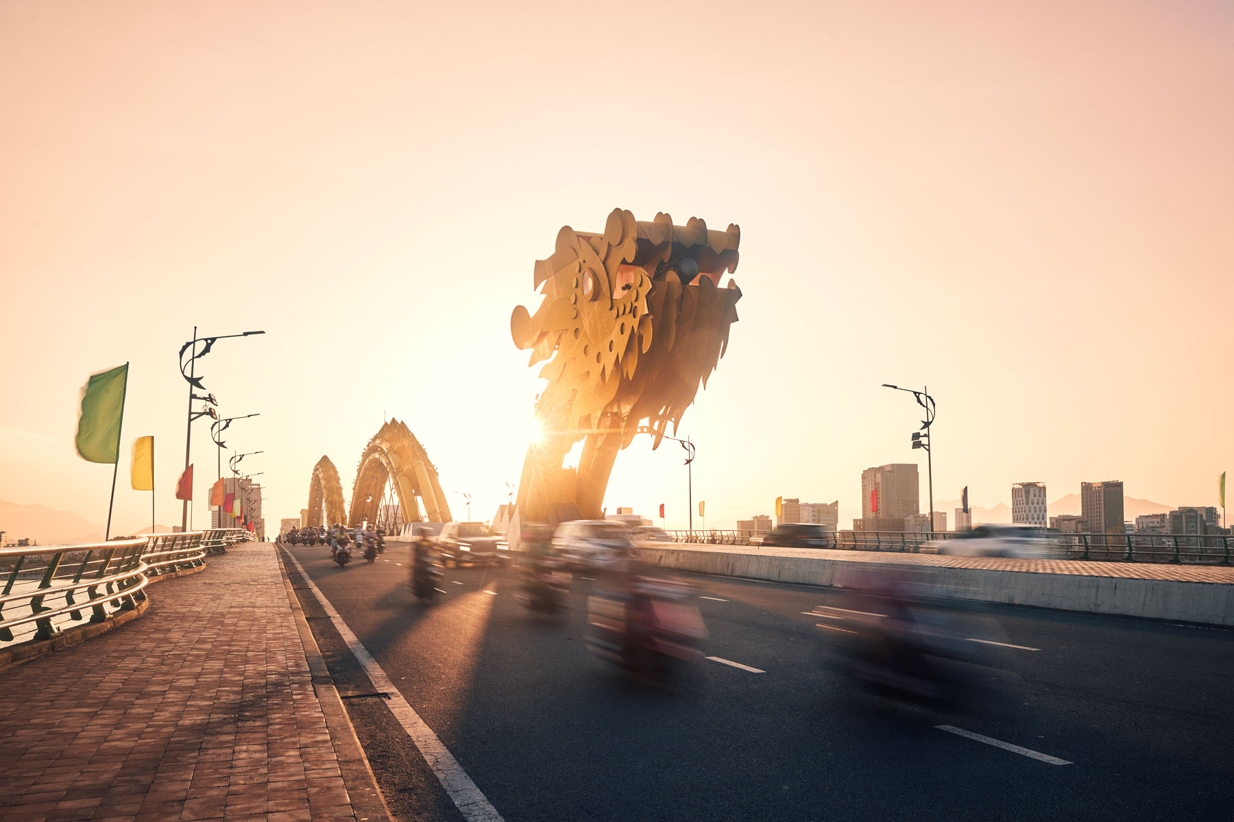 Traffic on Dragon Bridge at golden sunset