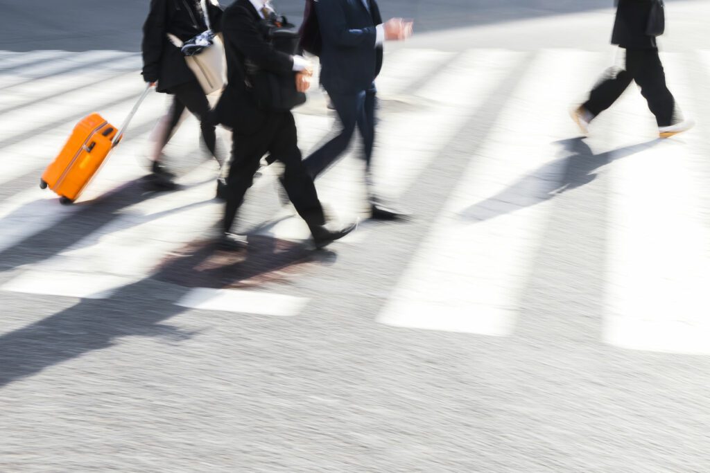 Business men crossing a city street on a zebra crossing