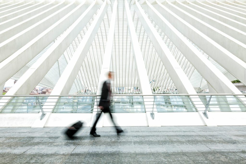 otion blurred business commuter walking, pulling luggage