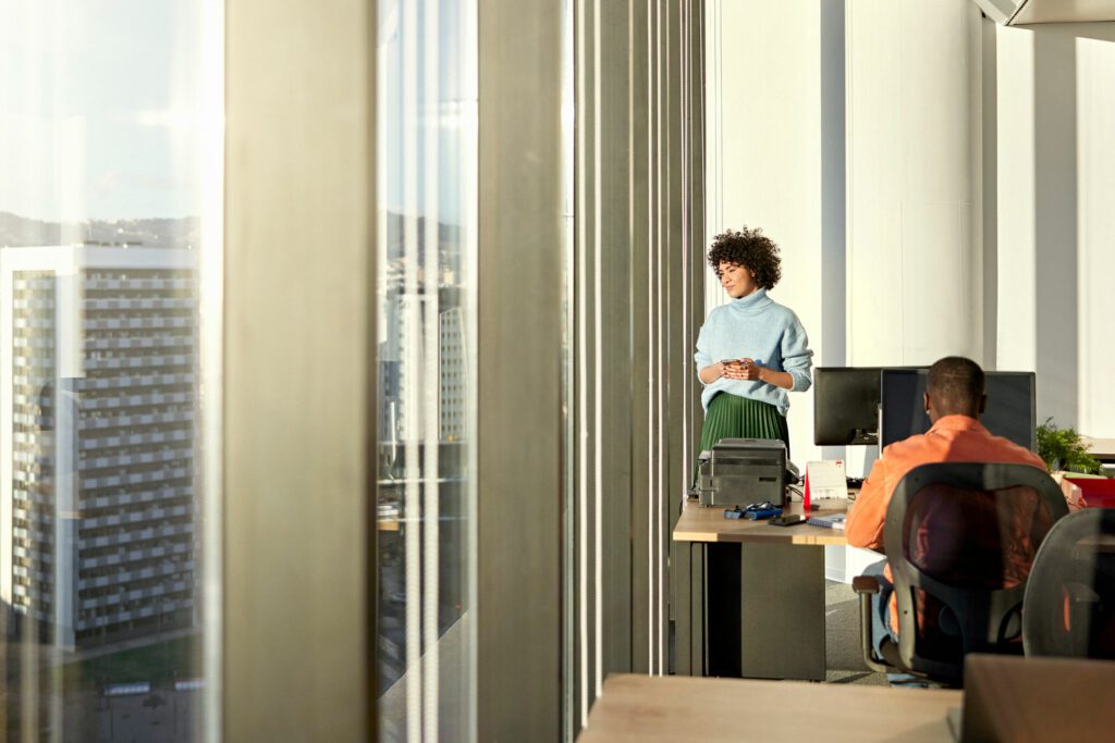 Young businesswoman looking at view from modern office