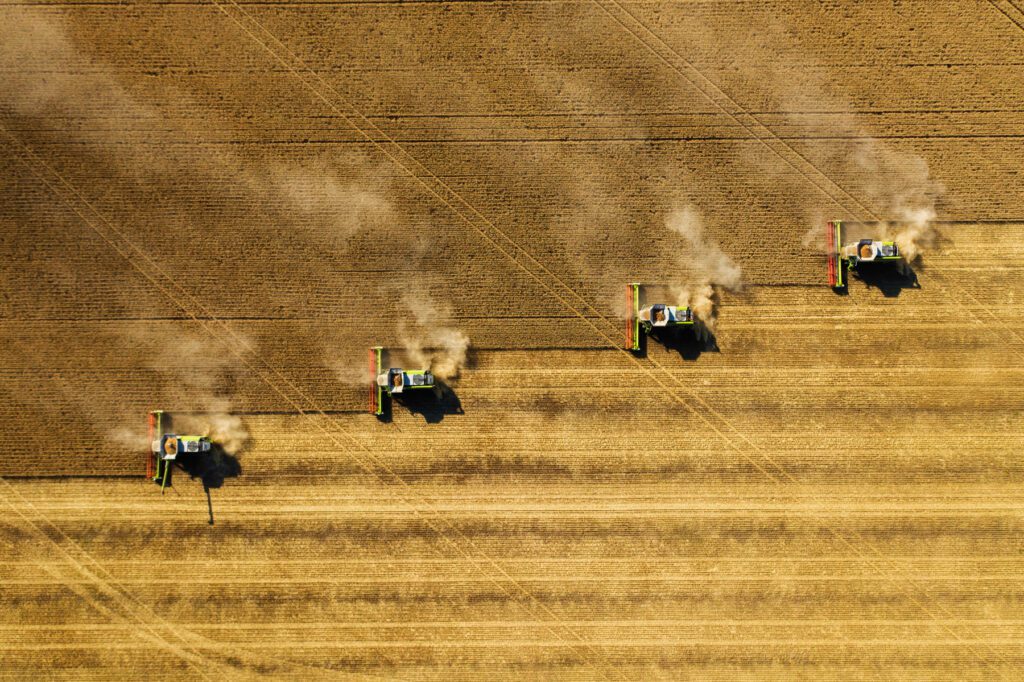 Farm machinery ploughing fields