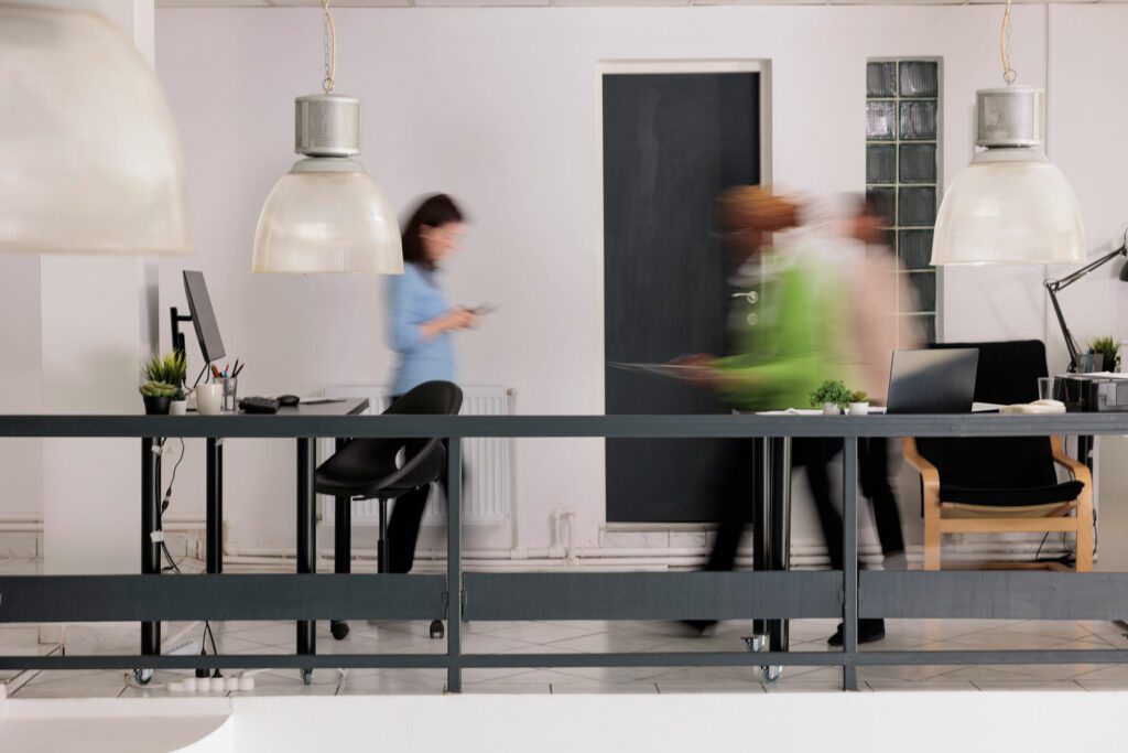 Diverse employees silhouettes walking in business coworking space