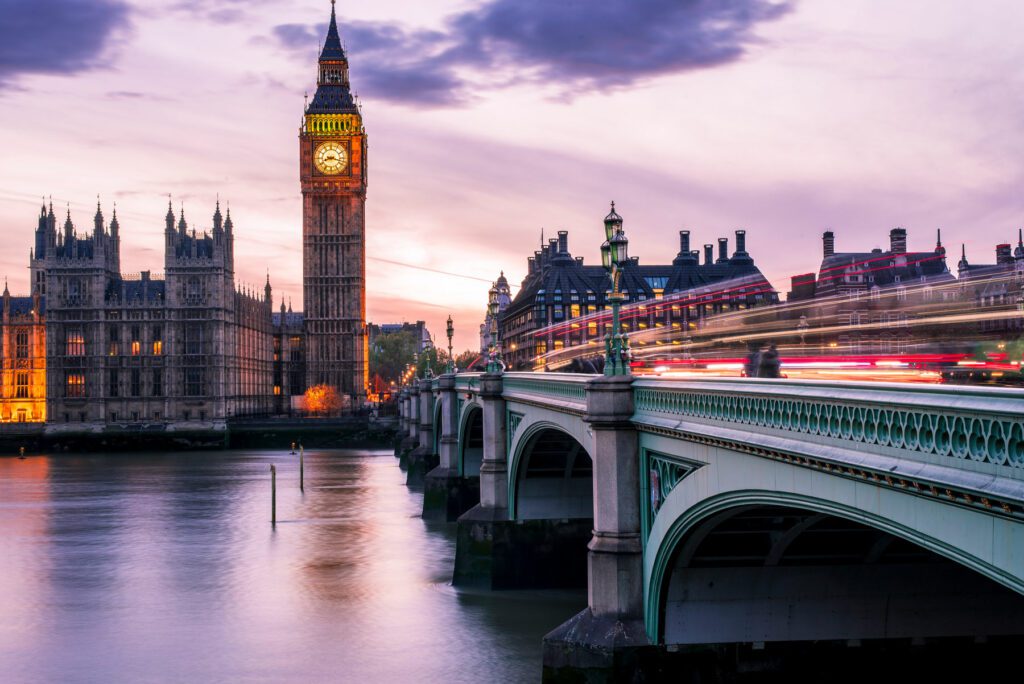 Big Ben at night and Westminster bridge with red and blue car light trails