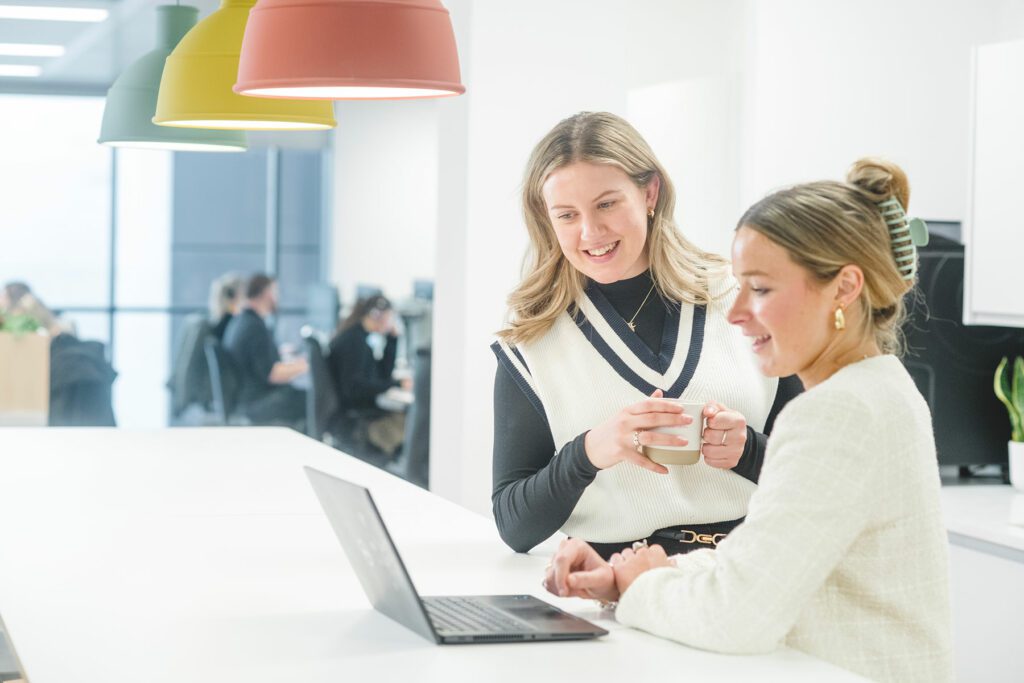 Two women looking at laptop in Michelmores office