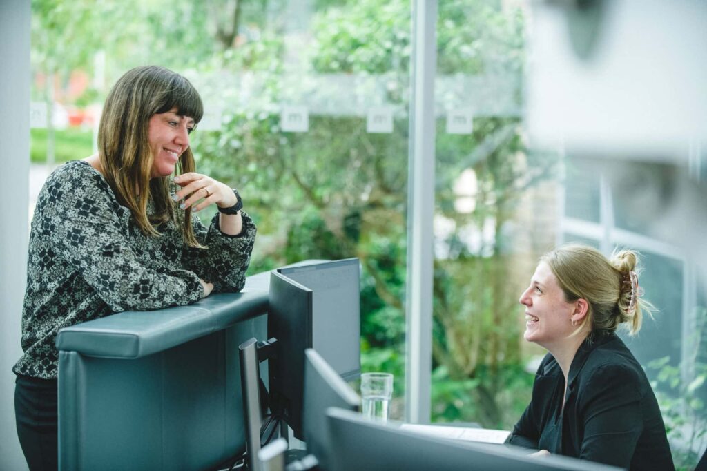 Lawyer speaking to receptionist in Michelmores Exeter Office