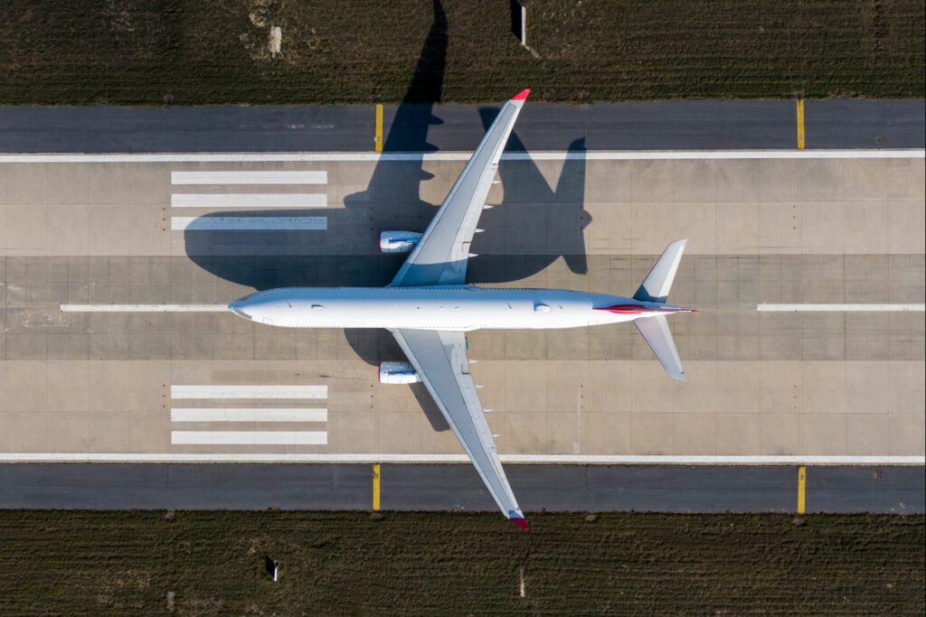 Aerial drone photo of air planes as seen from above docked in airport space