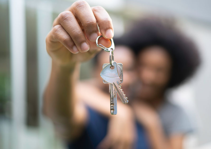 Couple holding set of keys to their new property