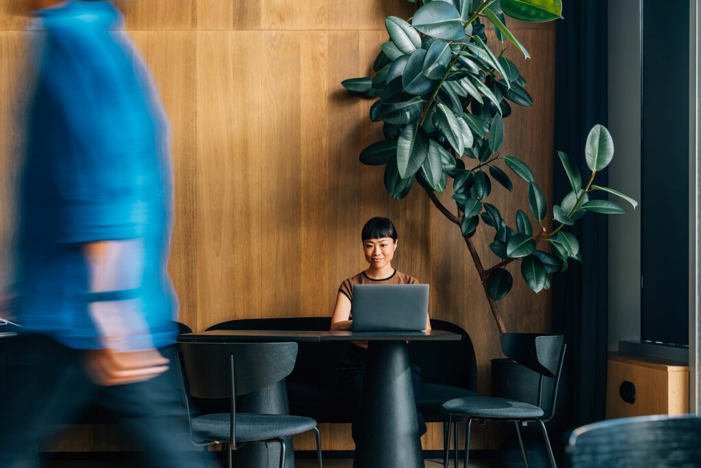 Asian businessworking on her laptop in a stylish modern workspace