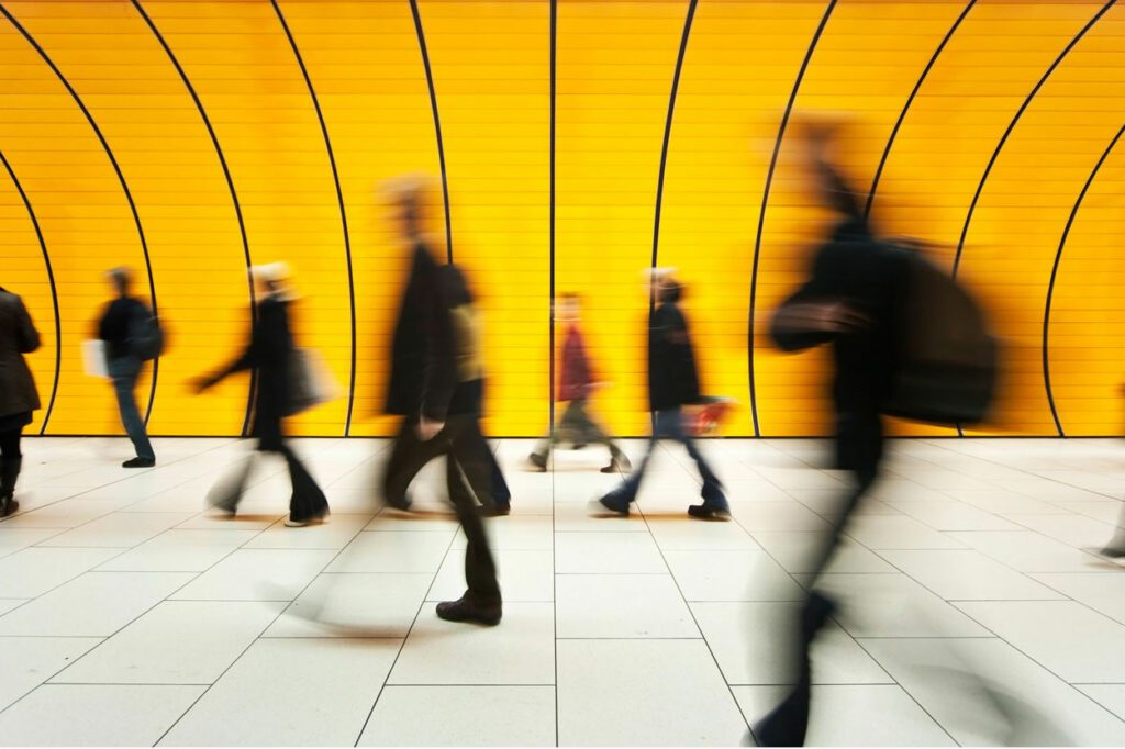 Blurred motion of people walking through tunnel
