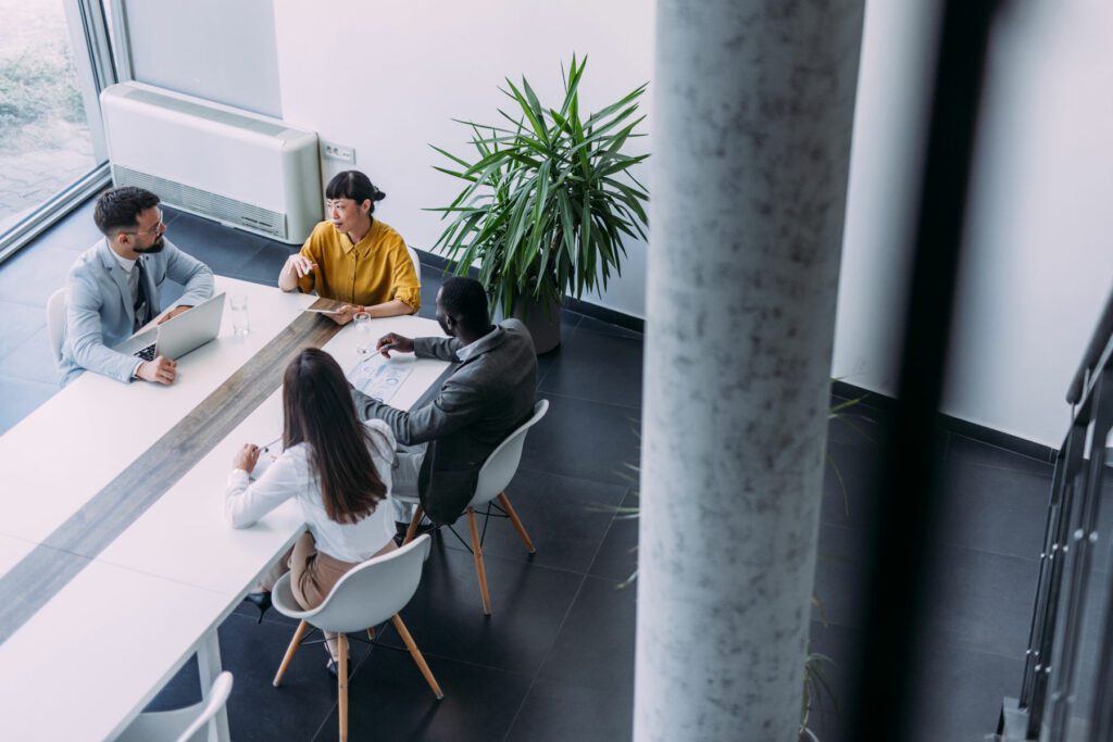 Above view of group of business persons in business meeting.
