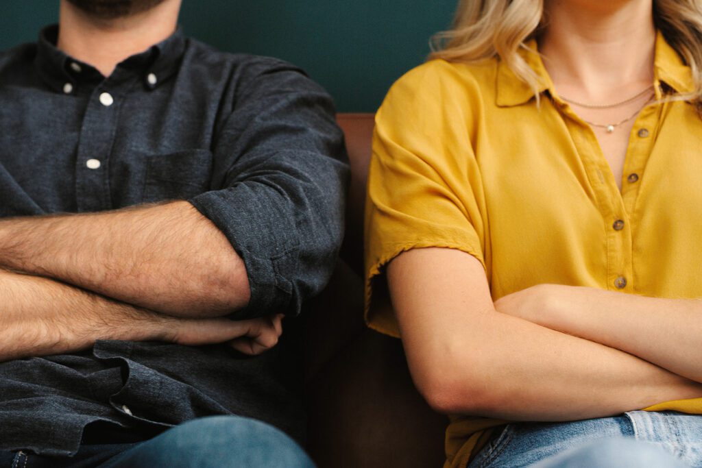 Divorced couple sat on sofa