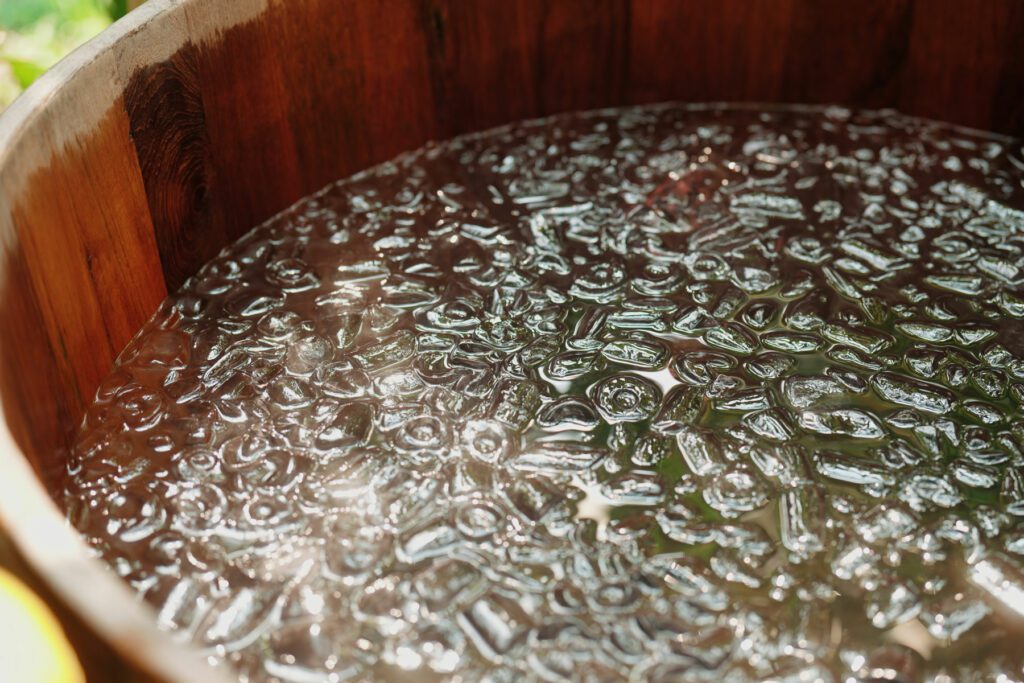 Wooden barrel packed with ice, perfectly prepared for a refreshing ice bath.