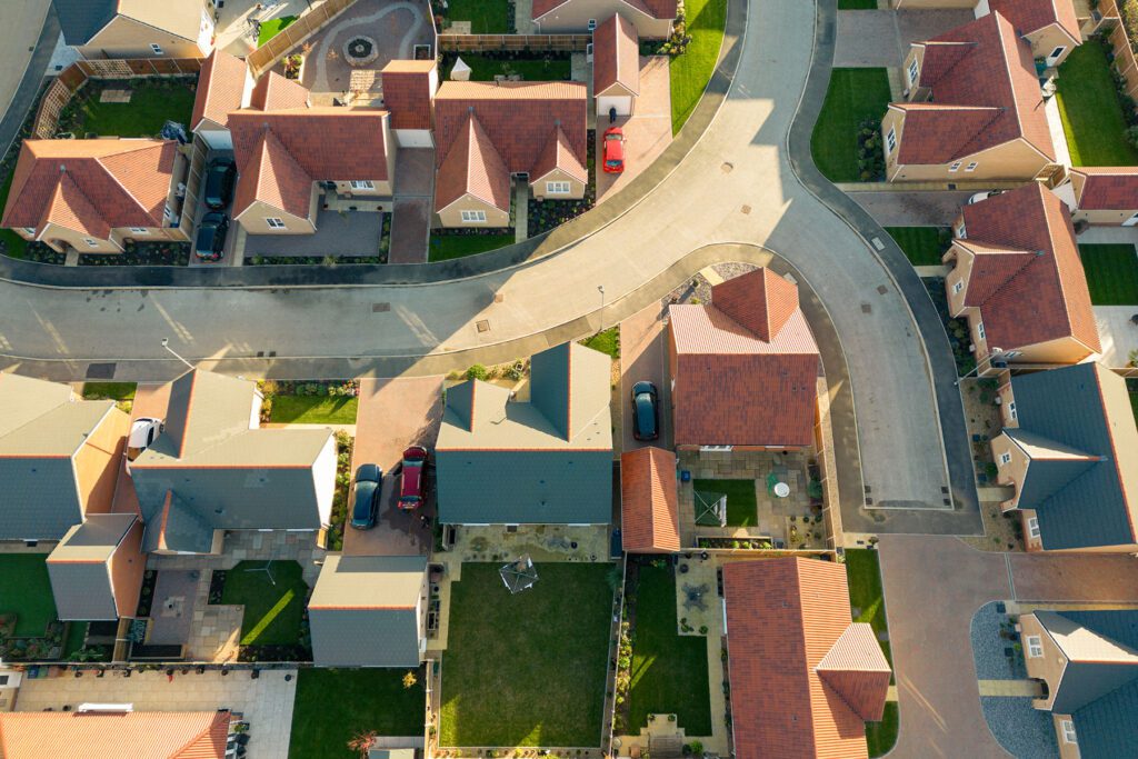 Drone view of detached retirement bungalows seen during dusk.
