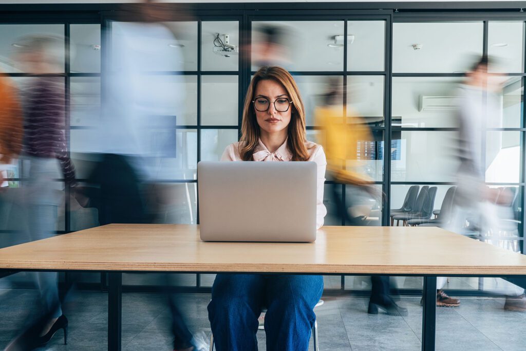 women sat in busy office environment
