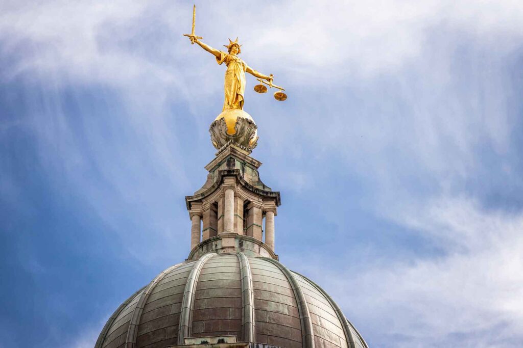 A gilded statue of Lady Justice on the dome above the Central Criminal Court building in central London.