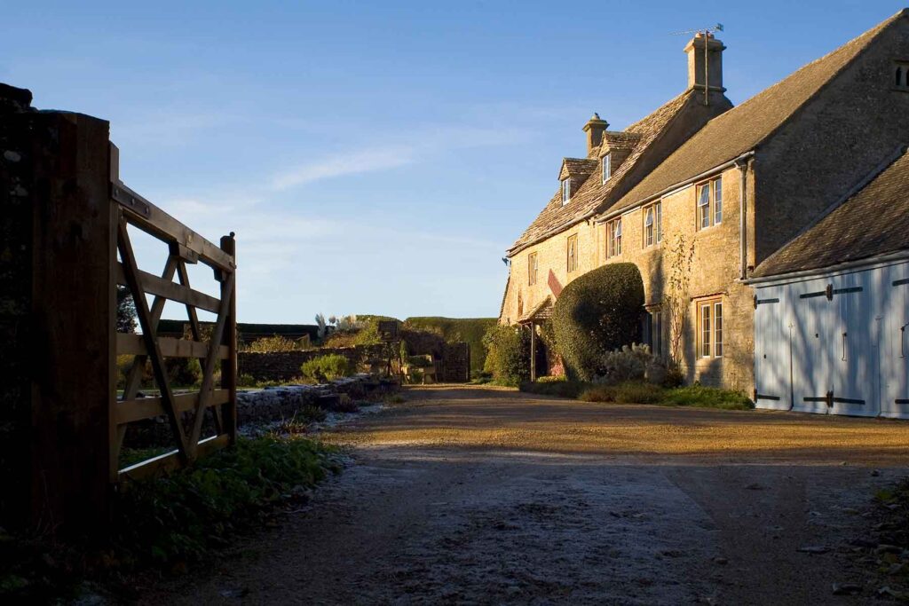 A large country cottage styled house with farm yard gates