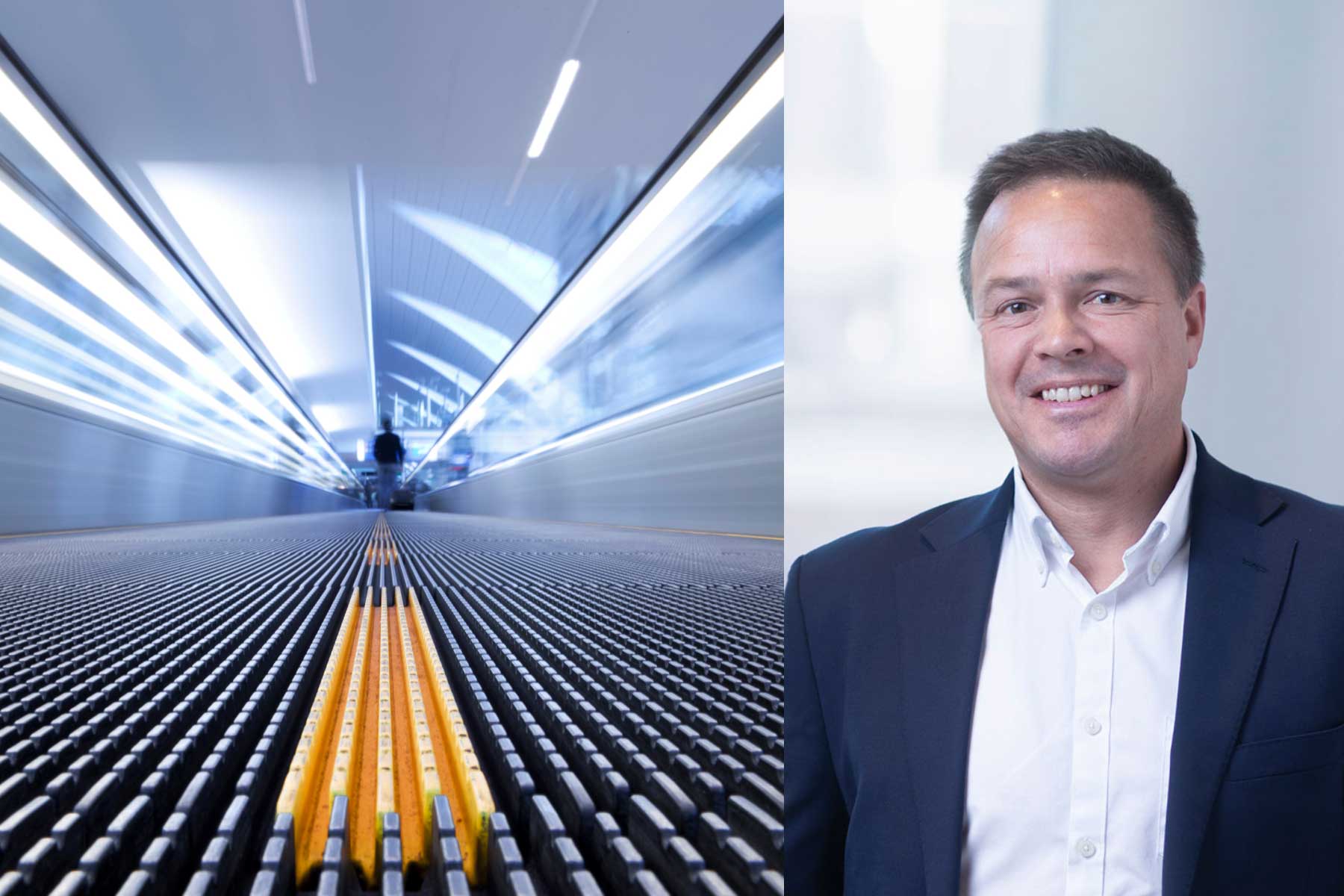 A blurred moving travelator on the left, viewed from a low angle, with a smiling man in a suit standing against a light background on the right.