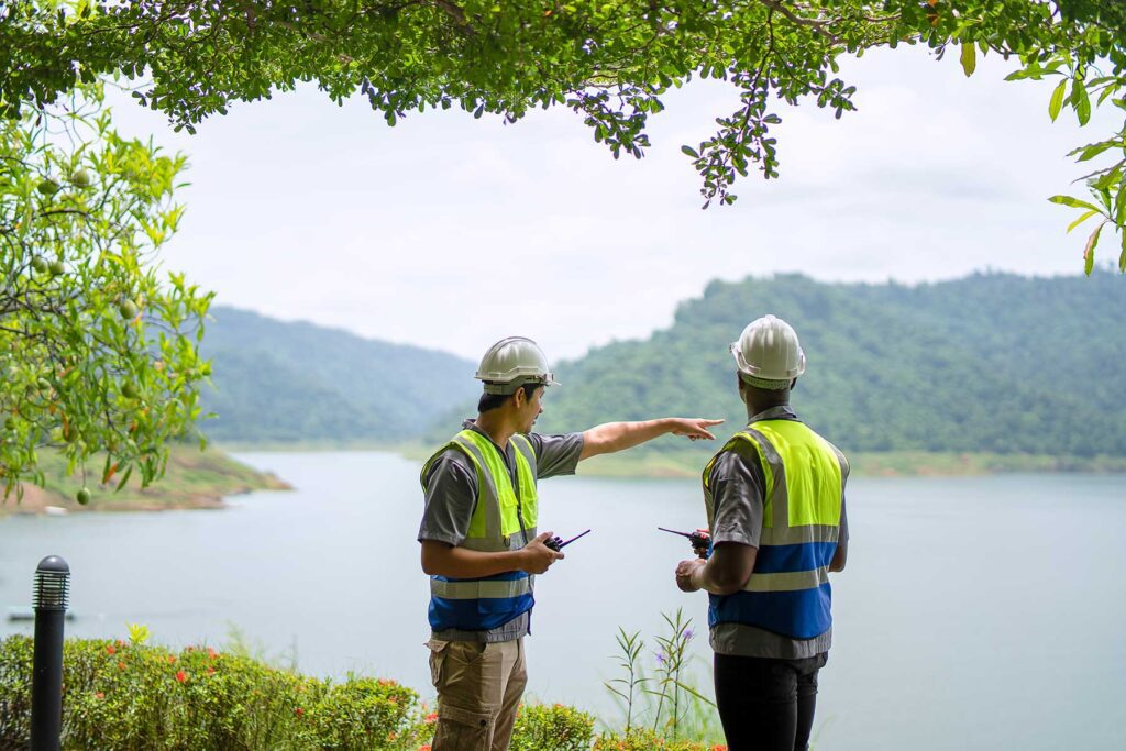 An environmentalist and engineer check reservoir