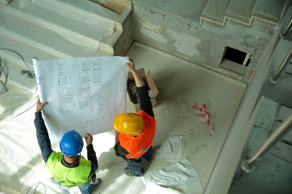 Construction workers reading blueprints.