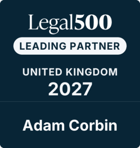 A dark blue badge reads: Legal500 LEADING PARTNER UNITED KINGDOM 2027 Adam Corbin.