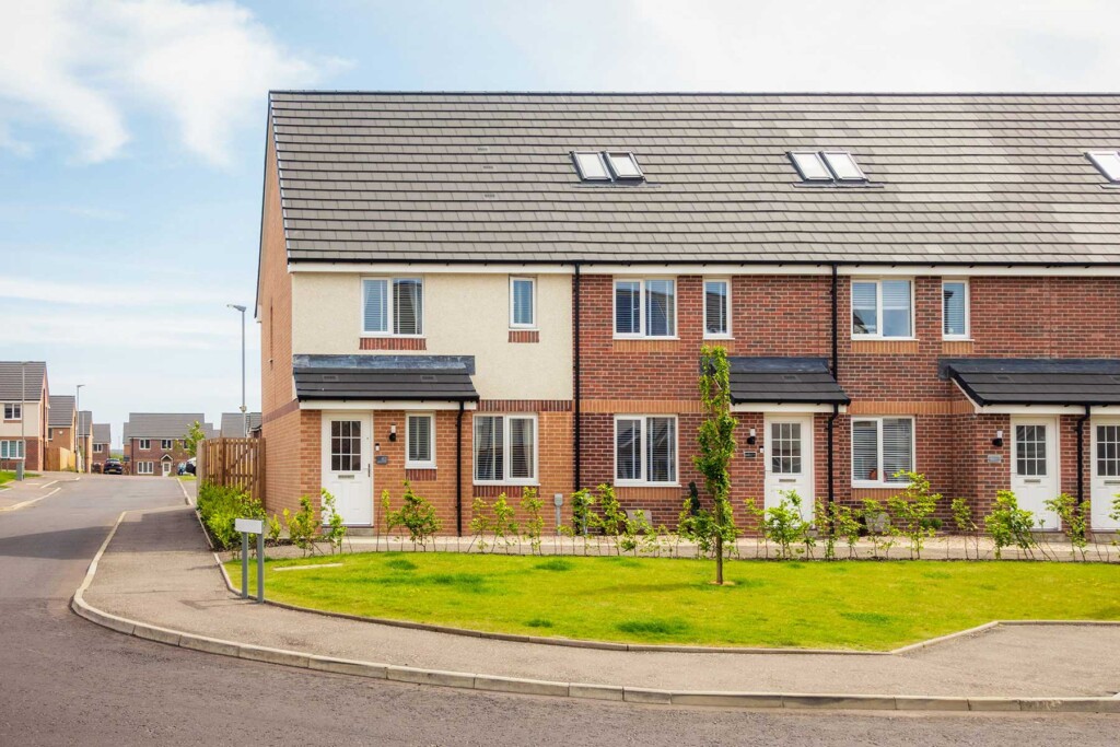 A row of modern brick and render terraced houses with small front gardens and a curved pavement.